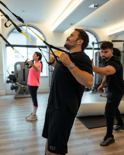 Couple doing a personal training session using the TRX with Max Sutton