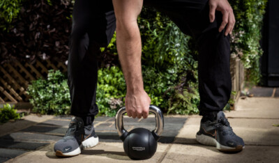Lifting a kettle bell in the yard - our outdoor training space